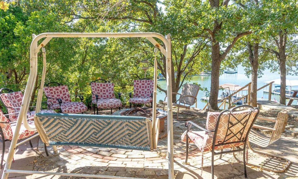 Nocona House | Charming Waterfront Lake Nocona House Cozy 2BR, 2BA lake house with 3 beds + futon on Lake Nocona. Vintage charm meets modern amenities. Enjoy a fully equipped kitchen, multi-level patio with lake views, outdoor seating, grill, and fire pit.