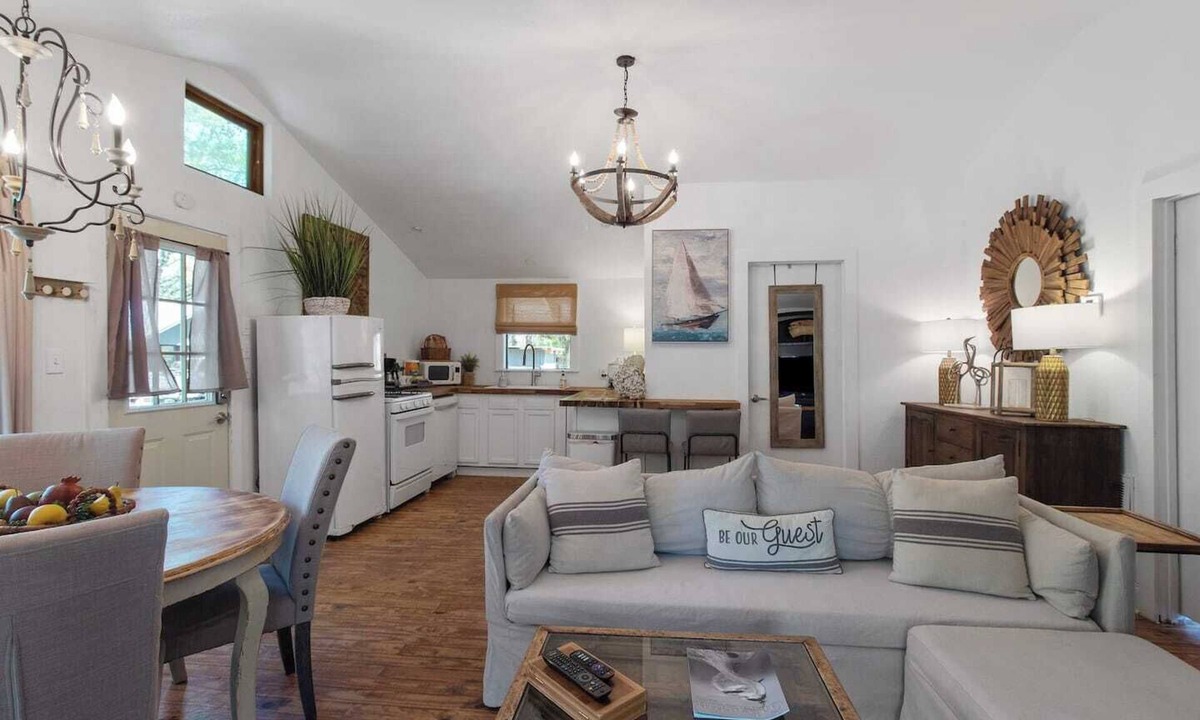Shreveport Cabin | Emerald Cottage offers a laid-back stay surrounded by towering trees, with a spacious deck, kayaks and canoes to paddle through the cypress forest, and a firepit perfect for slow evenings outside.