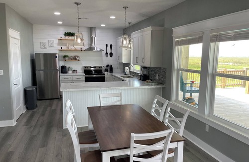 Port Bolivar Cabin | Beautiful Canal front Cabin, Golf Cart Ride to Beach, 2 miles New Rollover Pier