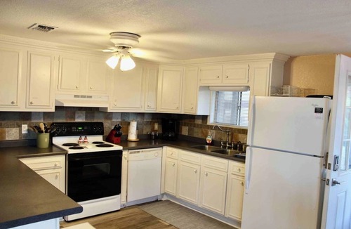 Nocona House | Charming Waterfront Lake Nocona House Cozy 2BR, 2BA lake house with 3 beds + futon on Lake Nocona. Vintage charm meets modern amenities. Enjoy a fully equipped kitchen, multi-level patio with lake views, outdoor seating, grill, and fire pit.