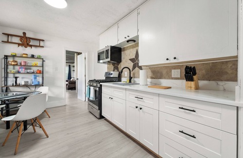 Westworth Village House | Cleared for Landing: The Pilot's Lounge. 4BR TV Every Bedroom Exterior Patio