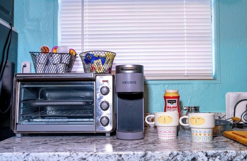 Saint Jo Cabin | Cozy downtown studio for 2 within walking distance to Red River Station. Features a king bed, kitchenette, smart TV, Wi-Fi, free parking, and a peaceful private patio.