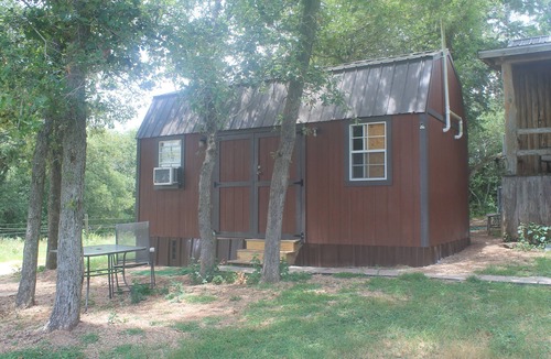 Red Rock Cabin | Cozy Ranch Cottage, Red Rock, Texas. One bedroom with in suite bathroom.