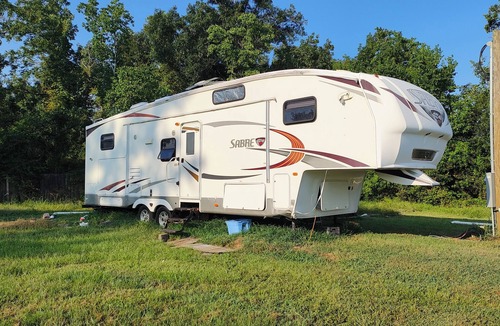 Ragley House | Cozy RV has 2 bedrooms, an outdoor kitchen with a grill & fridge