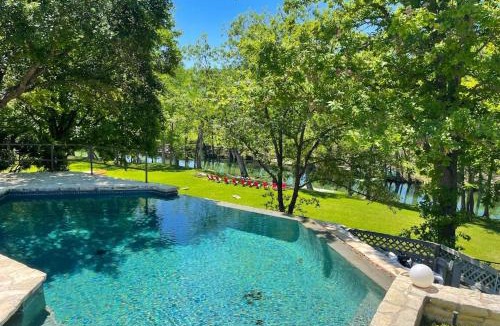 Hunt House | Inviting Waterfront Home with Pool, Patio, Fireplace, W/D, & Dog-Friendly