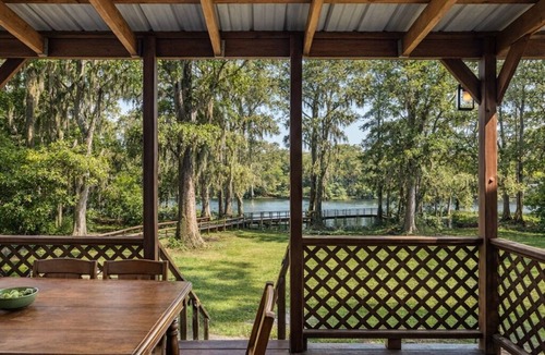 Uncertain House | Lakefront cabin with sweeping views of Caddo Lake, lakeside to the pier and kayaks, plus a foosball table for fun downtime.
