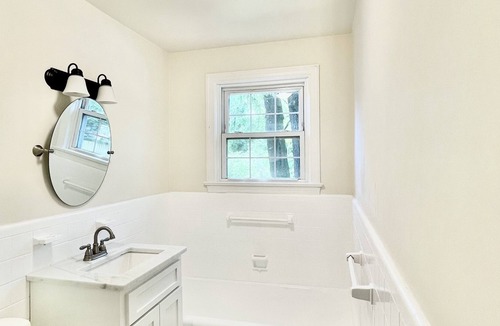 Midtown Cottage | Quaint cottage style home with two sitting areas-2 minutes to shops and eateries