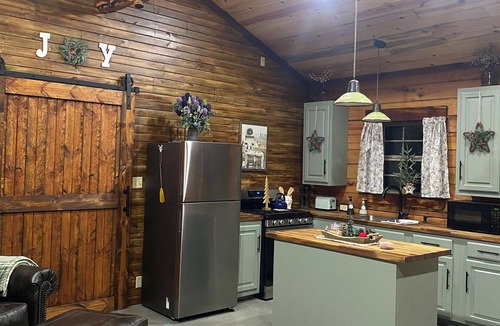 Tishomingo Cabin | The Cozy Pines is a newly built, romantic log cabin with a 2-sided fireplace.