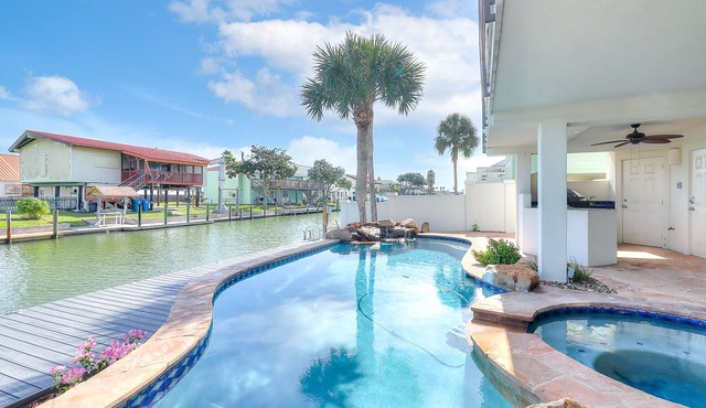 Canal-front home with saltwater pool, pool spa, kayaks, dock, & casita