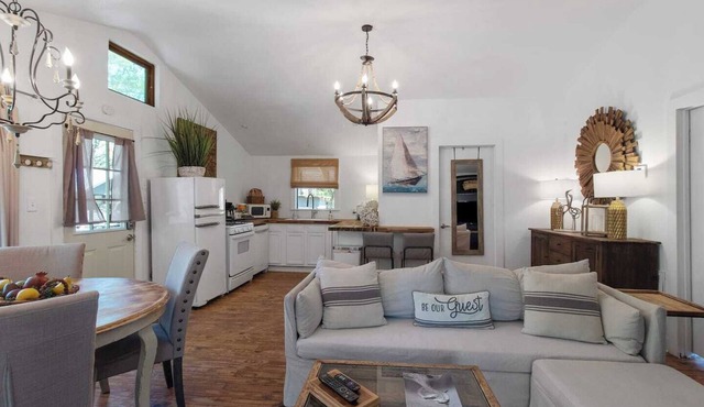 Emerald Cottage offers a laid-back stay surrounded by towering trees, with a spacious deck, kayaks and canoes to paddle through the cypress forest, and a firepit perfect for slow evenings outside.