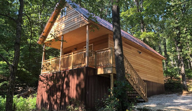 Farmer cabin is nestled in our little woodland village – playground, pond & more