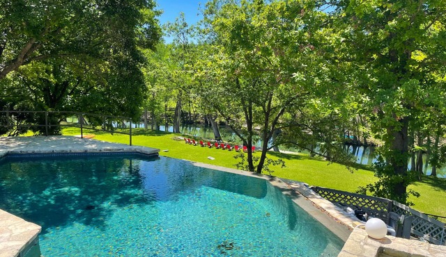 Inviting waterfront home with pool, patio, fireplace, W/D, & dog-friendly