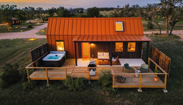 Luxury cabin in the TX Wine Country with porch, hot tub, grill and fire pit.