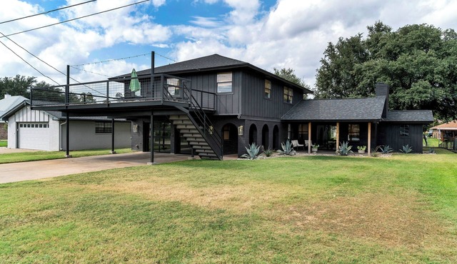 Rockstar waterfront lake house! Mid century modern with large 2 story party deck