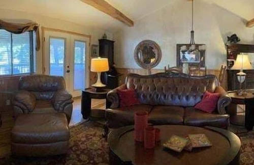 Mount Ida Cottage | Lake view two bedroom, two bath log-sided cottage with private hot tub overlooking Lake Ouachita. by RedAwning